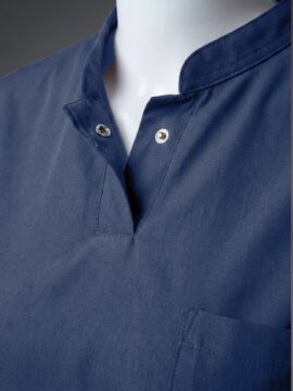 A close up photo of a fashionable blue collared scrub on a mannequin.