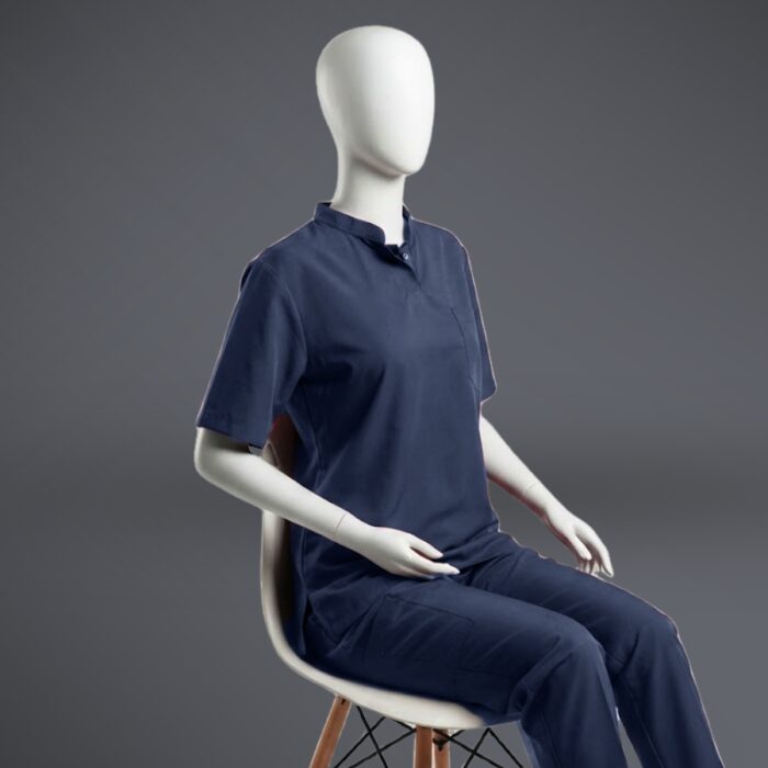 Collared blue scrub sitting A stylish blue collared scrub with on a sitting mannequin.