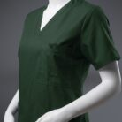 A close up photo of a fashionable green Pocketed scrub on a mannequin.