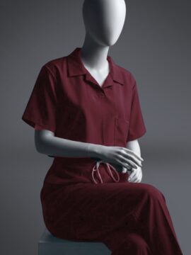 A stylish maroon T-shirt scrub with on a sitting mannequin.