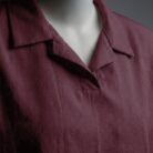 A stylish maroon t shirt on a mannequin close up view