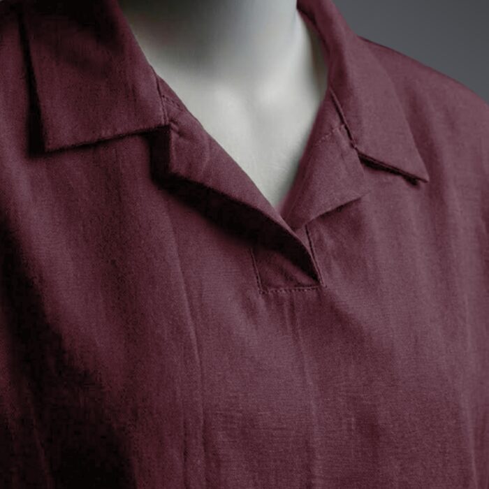 A stylish maroon t shirt on a mannequin close up view