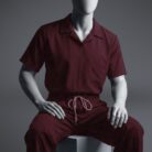 A stylish maroon t shirt scrub view on a sitting mannequin
