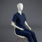 A stylish blue V-neck scrub with fashionable cuts on a sitting mannequin.