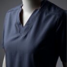 A close up photo of a blue fashionable V-neck design scrub on a mannequin.
