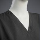 A close up photo of a fashionable black minimal scrub on a mannequin.