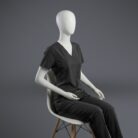 A stylish black minimal scrub with on a sitting mannequin.