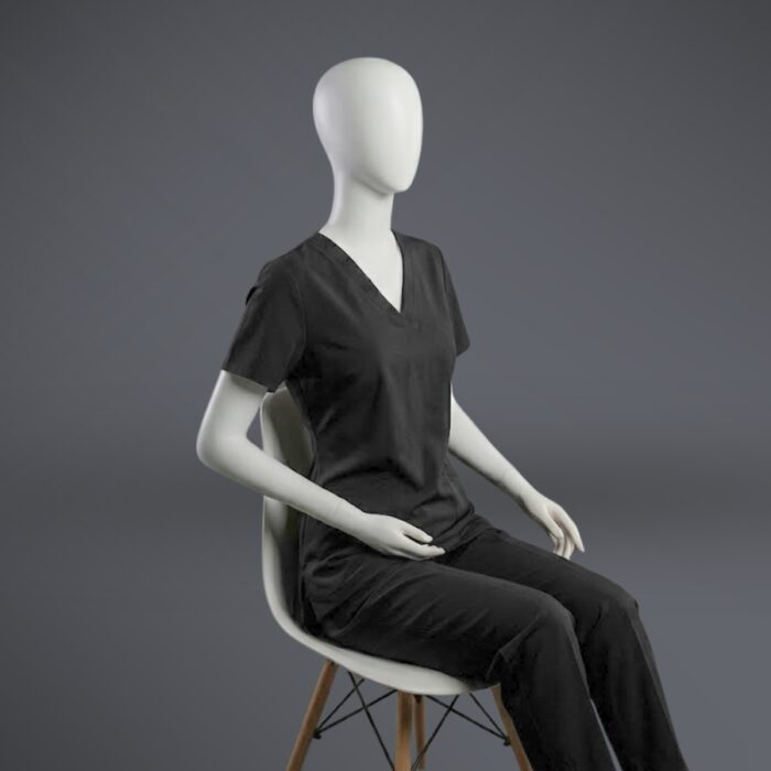 V-neck scrub black sitting A stylish black minimal scrub with on a sitting mannequin.