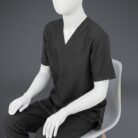 A stylish black minimal scrub with on a sitting mannequin.